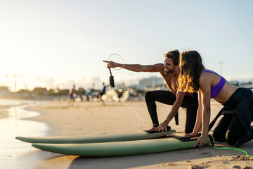 Wall Mural - Surfers are pointing and looking at waves.