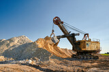 Fototapeta  - Shovel mining excavator operates in large open chalk quarry