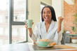© kues1 - black afro woman feeling shocked,laughing and celebrating success. breakfast concept