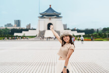 Woman Traveler Visiting In Taiwan, Tourist With Hat Sightseeing In National Chiang Kai Shek Memorial Or Hall Freedom Square, Taipei City. Landmark And Popular Attractions. Asia Travel Concept