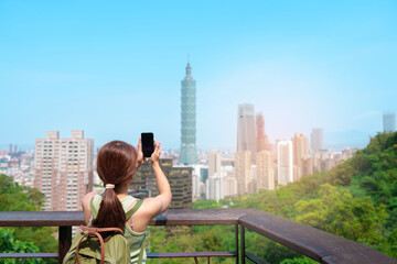 woman traveler visiting in Taiwan, Tourist looking Taipei City during sightseeing and hiking at Elephant Mountain or Xiangshan, landmark and popular attractions. Asia Travel, vacation and Trip concept