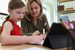 © megaflopp - Female teacher explains educational material to schoolgirl