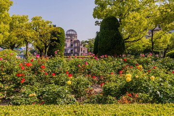 Landscape of flower garden at Peace Memorial Park with a-bomb dome in background.