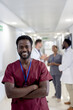© WavebreakMediaMicro - Unaltered portrait of african american male doctor smiling in corridor, copy space
