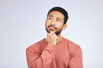 Wall Mural - Face, man and thinking of idea in studio or planning, decision and choice with white mockup background. Asian male, model and curious with doubt, questions or thoughtful guy, confused or remember