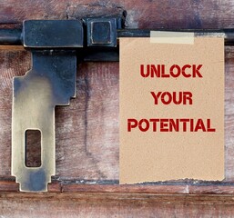 Wood door with steel old style lock, text in note UNLOCK YOUR POTENTIAL ,concept of stepping out from fear or comfort zone and challenging limiting belief, release your hidden talents