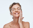 © Nicholas Felix/peopleimages.com - Skincare, smile and a woman with an anti aging cream isolated on a white background in a studio. Happy, moisturize and a mature model with facial lotion for beauty, wellness and care of skin