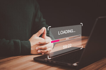 Poster - Young user using a laptop computer for download and update software with waiting to loading digital file data form website, very slow internet form wifi. Concept of waiting for load of loading symbol.