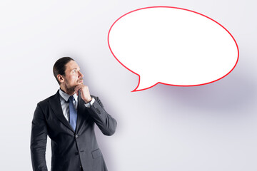Aufkleber - Attractive young european businessman with speech bubble on white background. Opinion, speech and communication concept. Mock up place.