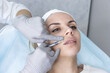 © Irina - A cosmetologist in medical gloves fills women's wrinkles with hyaluronic acid