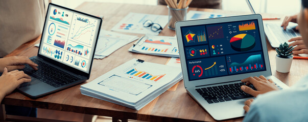 Leinwandbilder - Panorama shot analyst team utilizing BI Fintech to analyze financial report with laptop. Businesspeople analyzing BI power dashboard displayed on laptop screen for business insight. Scrutinize