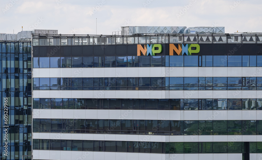 The logo sign of NXP Semiconductors company on top of the headquarters ...