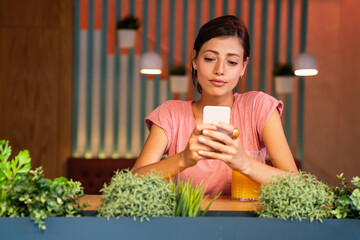 Wall Mural - Portrait og happy woman using mobile phone for work, study or social media. People technology