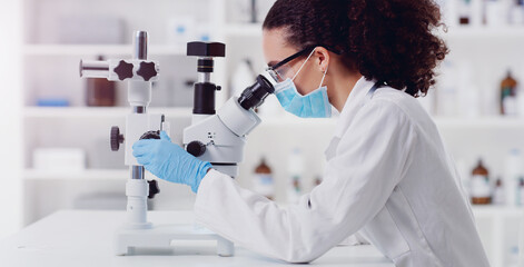 Microscope, research and woman scientist in a lab for science, medicine and data analysis. Laboratory, healthcare and female health expert checking medical, results and working on a cure for cancer