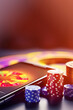 Online casino background. Smartphone with playing chips on table on blurred neon background. Internet gambling concept. Vertical format, copy space. Generative ai