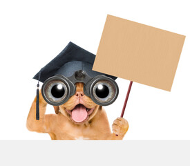 Aufkleber - Graduated mastiff puppy looks through binoculars above empty white banner and shows empty placard. Isolated on white background