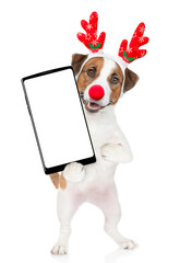 Poster - Jack russell terrier puppy dressed like santa claus reindeer  Rudolf holds big smartphone with empty screen in it paw, showing close to camera. isolated on white background