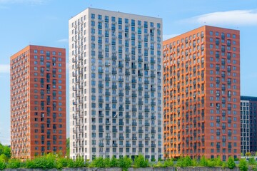 Wall Mural - Beautiful exterior of modern skyscrapers against a blue cloudy sky during daytime