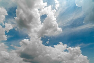 Beautiful fluffy white clouds against a bright blue sky background