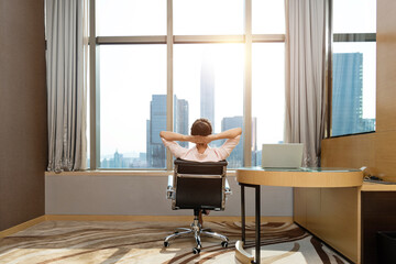 Wall Mural - Businesswoman sitting in front of the window