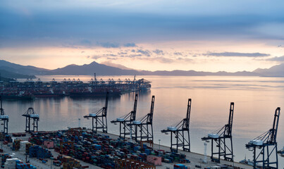 Wall Mural - Containers in the port at sunset