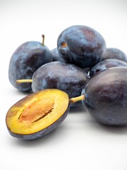 Wall Mural - Vertical closeup of plums isolated on a white background