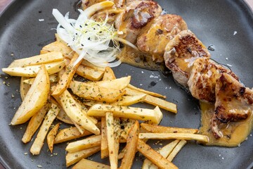 Poster - Closeup of plate of delicious Potato wedges and meat with onions