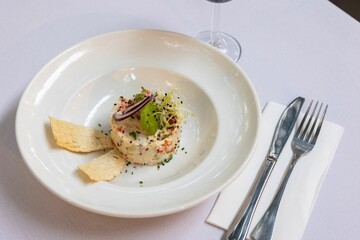 Poster - Closeup of a unique salad on a white plate laid on a table