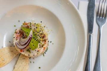 Poster - Top view of a unique salad on a white plate laid on a table