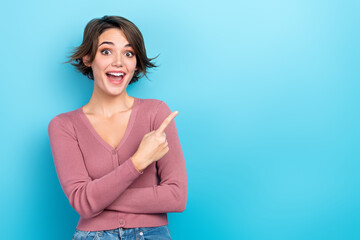 Photo of astonished positive girl open mouth indicate finger empty space isolated on blue color background