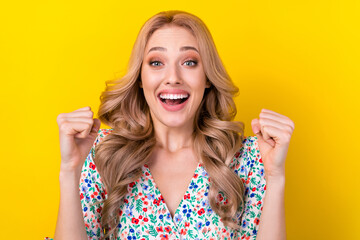 Wall Mural - Portrait of funny woman blonde curls fists up hooray wear stylish flower ornament victoria secret sale isolated on yellow color background