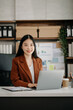 © Nuttapong punna - Business woman using tablet and laptop for doing math finance on an office desk, tax, report, accounting, statistics, and analytical research concept