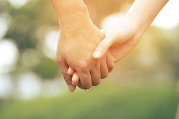 Wall Mural - Woman and man holding hands, Happy couple love in the garden. concept couple lover valentine day