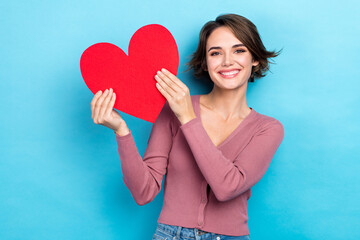 Poster - Photo of adorable pretty woman dressed pink shirt smiling rising red heart isolated blue color background