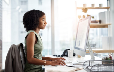 Computer, typing and business woman in office for online research, copywriting and editing for job website. Young african person, editor or journalist on desktop pc or monitor for article or report