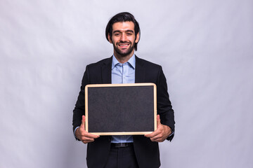 Wall Mural - Businessman holding chalk board on white background. Handsome businessman holding black board. Handsome man holding small framed blackboard