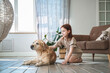 © iloli - Cute girl and fawn Labrador retriever at home