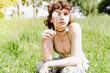 Portrait teenager girl with brown eyes curly hair with dandelion