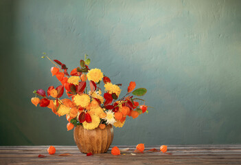 Wall Mural - beautiful autumnal  bouquet on wooden table on dark wall