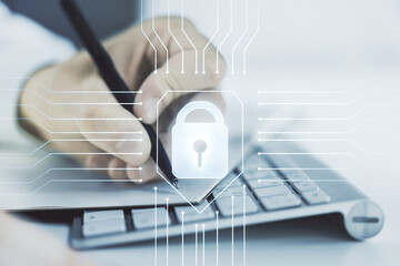 Poster - Double exposure of creative lock hologram with chip and hand writing in notebook on background with laptop. Information security concept