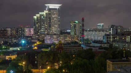 Wall Mural - Night Moscow cityscape from rooftop timelapse. Residential buildings at dark. Evening top view from the roof near railway station. Light in windows. Cloudy sky