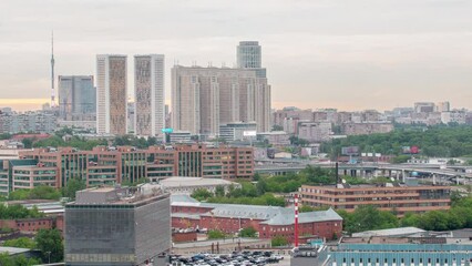 Wall Mural - Moscow cityscape from rooftop timelapse. Residential buildings and Ostankinskaya tv tower. Aerial top view from the rooftop. Traffic on the road. Cloudy sky at evening