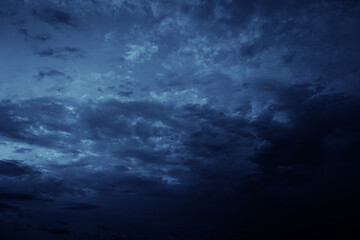 Wall Mural - black blue evening night sky with clouds. dark dramatic sky background. before the storm, thundersto