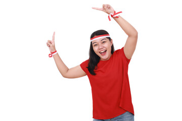 Young Indonesian girl celebrate indonesia independence day while pointing something on blank space