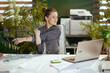 © Alliance - happy modern business woman at work stretching hands