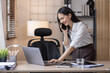 © David - Happy caucasian young Asian woman using smart phone cellphone for calls, social media, mobile application online in office money financial planning Business And Education Concept.
