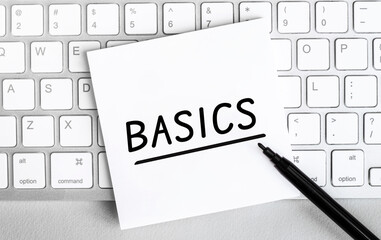 Poster - White paper with text basics lying on the keyboard