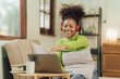 © Kritdanai - Focused young African female college student working on a laptop on living room.