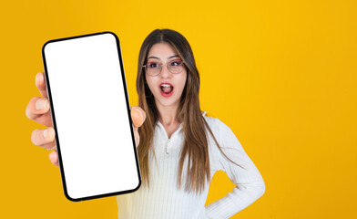 Amazing application advertising concept image of shocked, amazed, surprised woman holding, showing empty screen big smartphone for mockup. Portrait of excited caucasian girl. Copy space for ad.