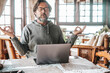 © simona - One serene adult man in relax position in front of a laptop after work. Keeping calm during smart working. People wellbeing at home using computer and doing yoga meditation. Problems and troubles